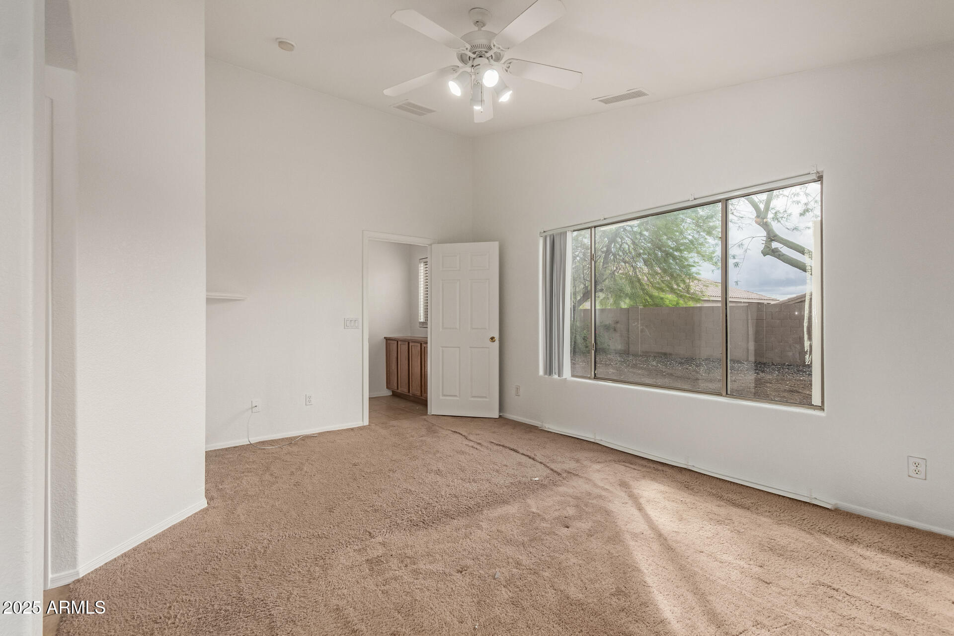 17573 West Dalea Drive Goodyear, AZ 85338 - Photo 16 of 29 an empty room with a window and a ceiling fan