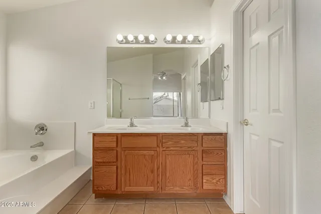 a spacious bathroom with a bathtub and a sink