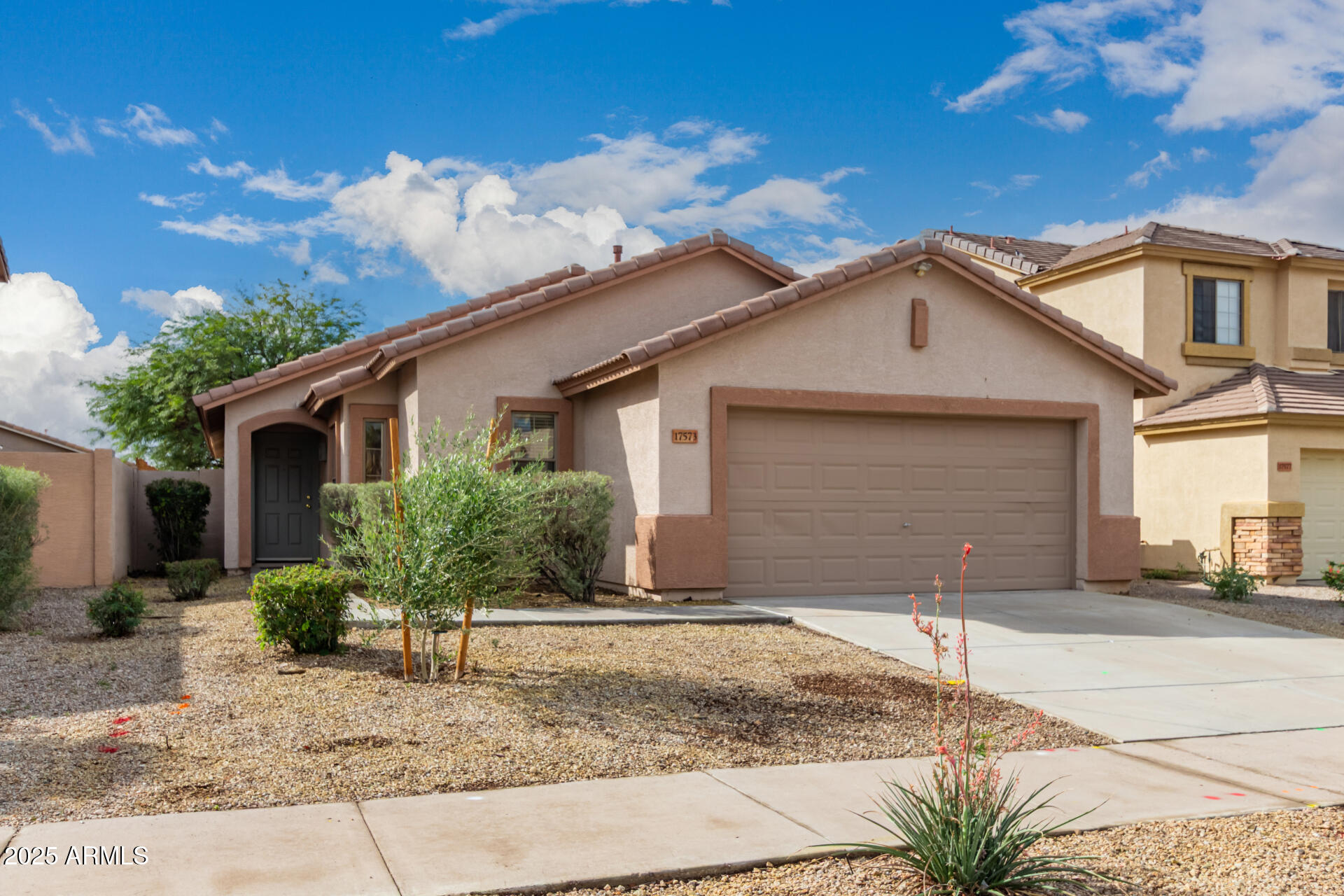 17573 West Dalea Drive Goodyear, AZ 85338 - Photo 2 of 29 a front view of a house with a yard and garage