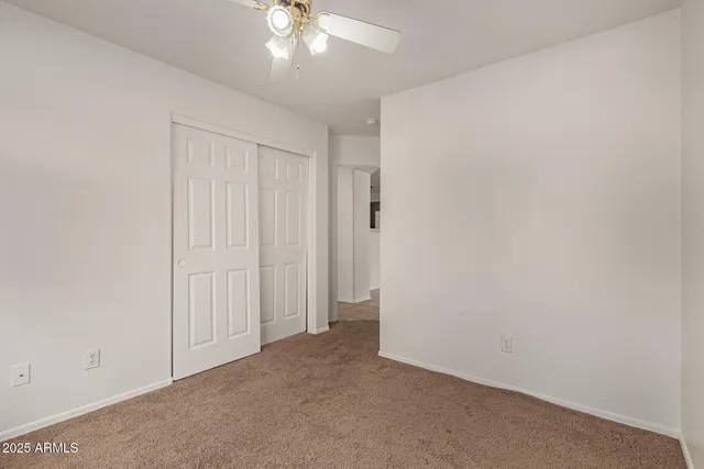 an empty room with a ceiling fan