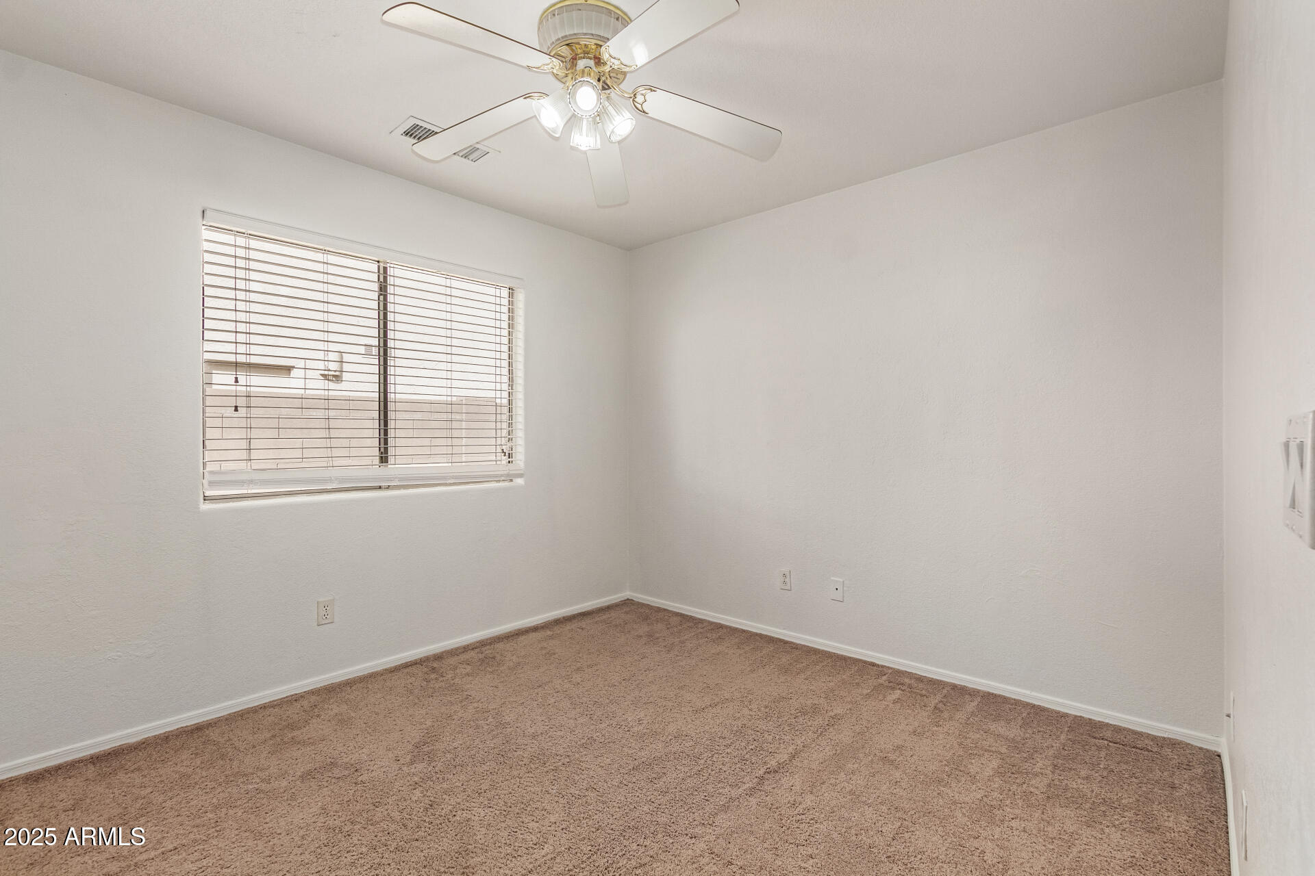 17573 West Dalea Drive Goodyear, AZ 85338 - Photo 22 of 29 an empty room with a window and a fan