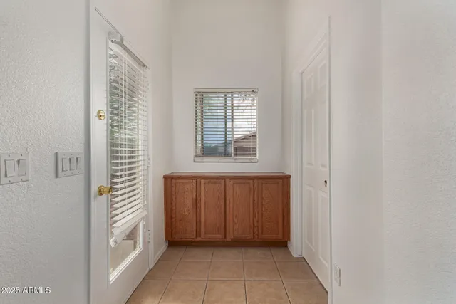 a view of front door with cabinets