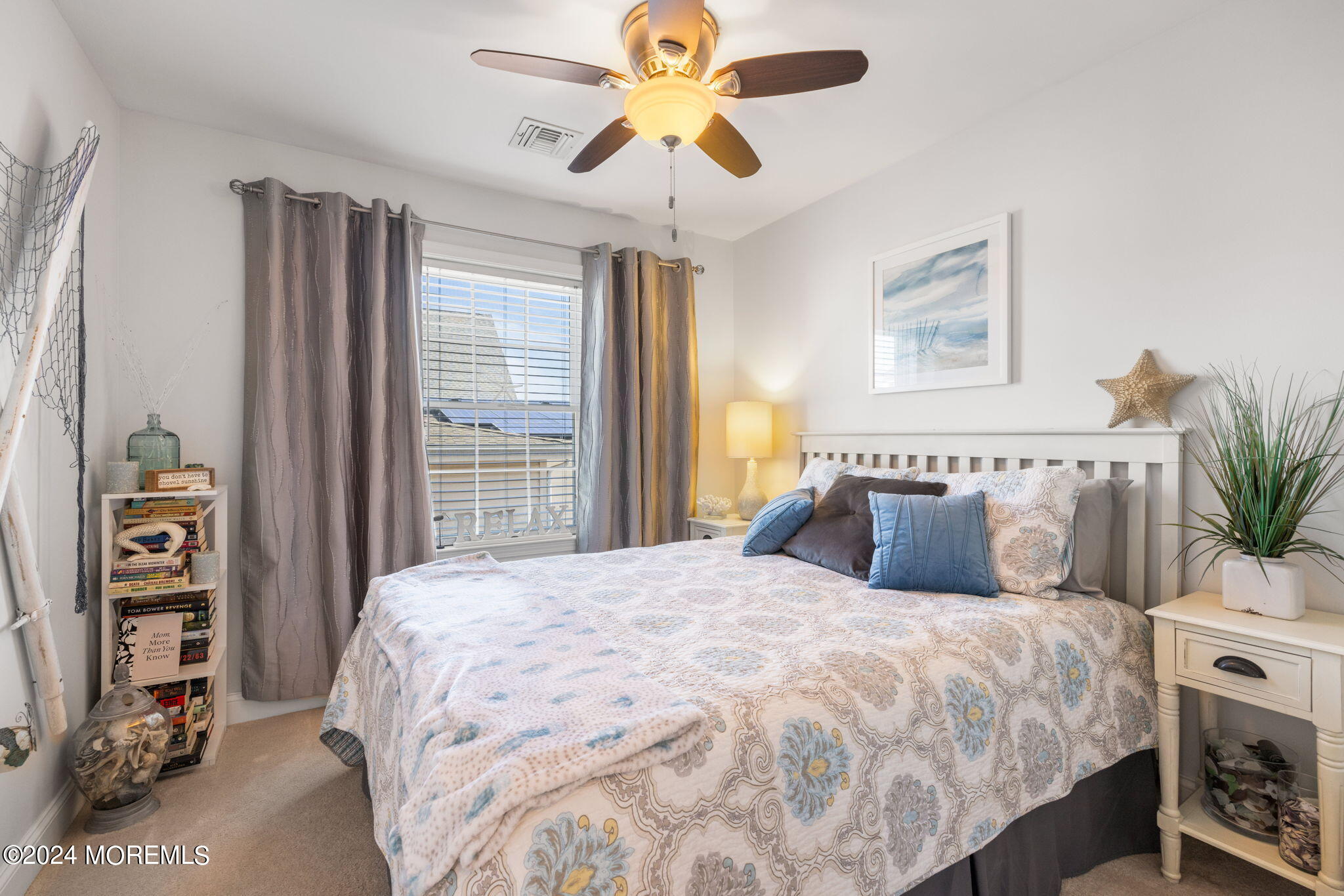 61 Rona Lane Beach Haven West, NJ 08050 - Photo 16 of 63 a bedroom with a large bed and a chandelier