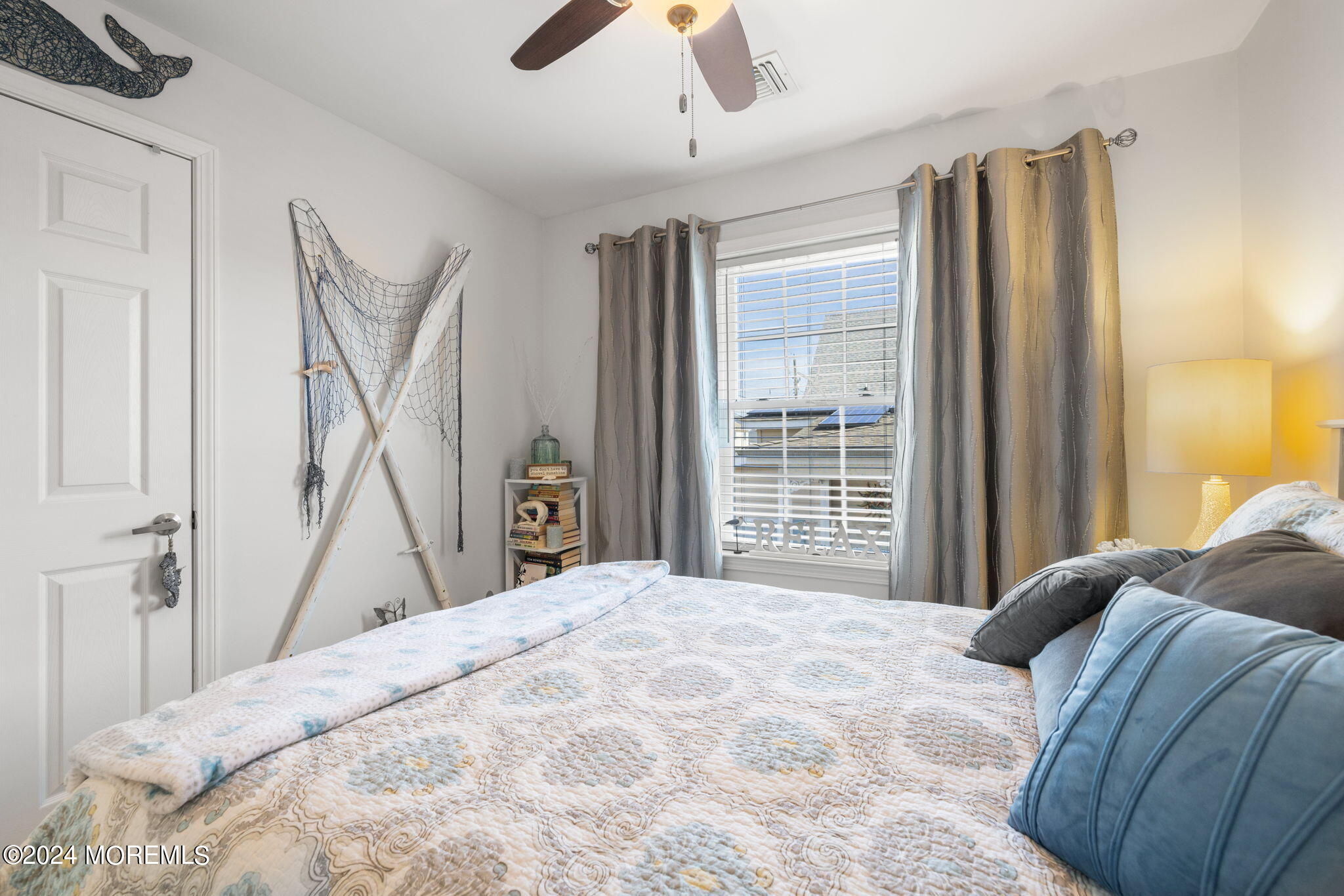 61 Rona Lane Beach Haven West, NJ 08050 - Photo 17 of 63 a bedroom with a large bed and a chandelier