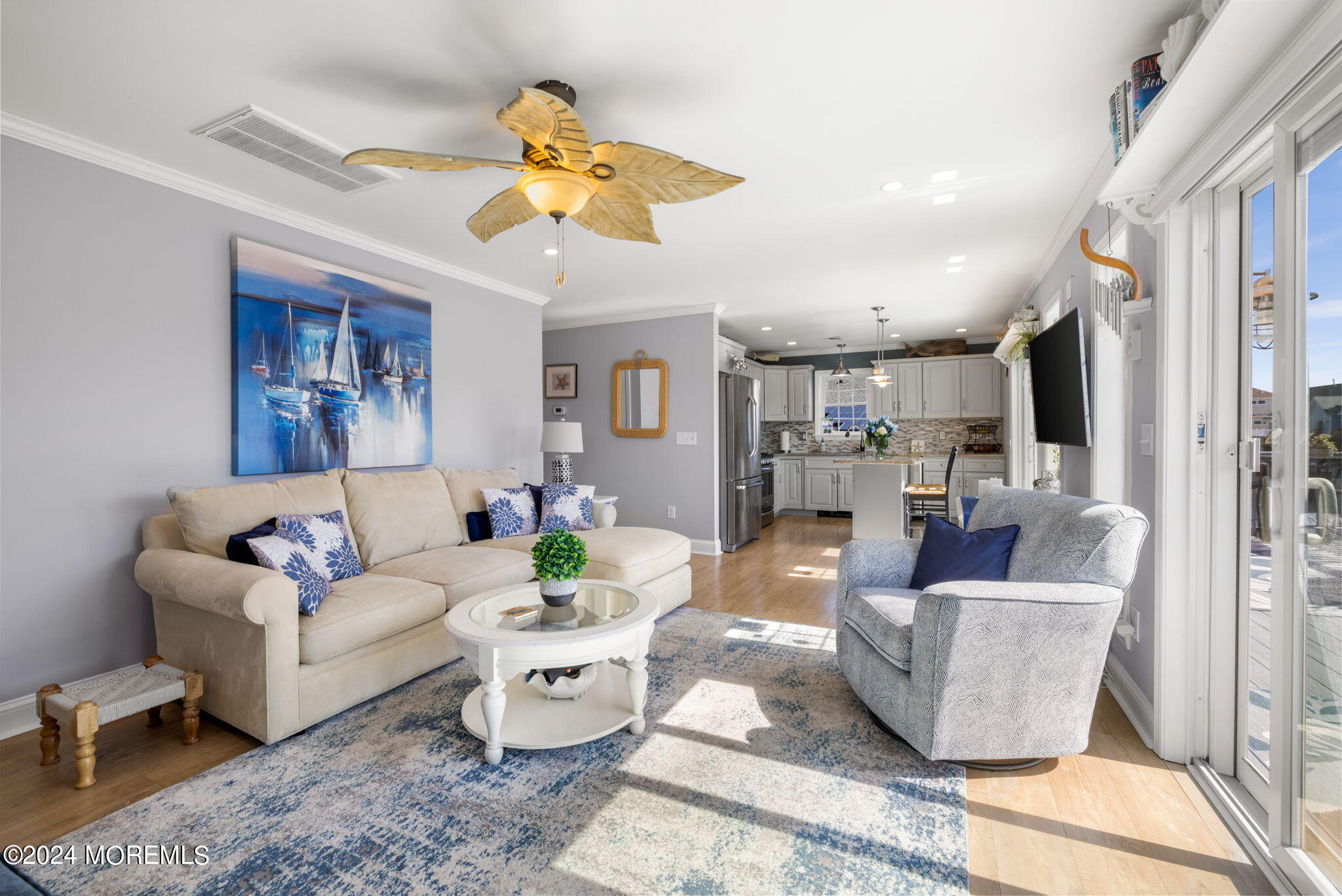 61 Rona Lane Beach Haven West, NJ 08050 - Photo 2 of 63 a living room with furniture and a chandelier