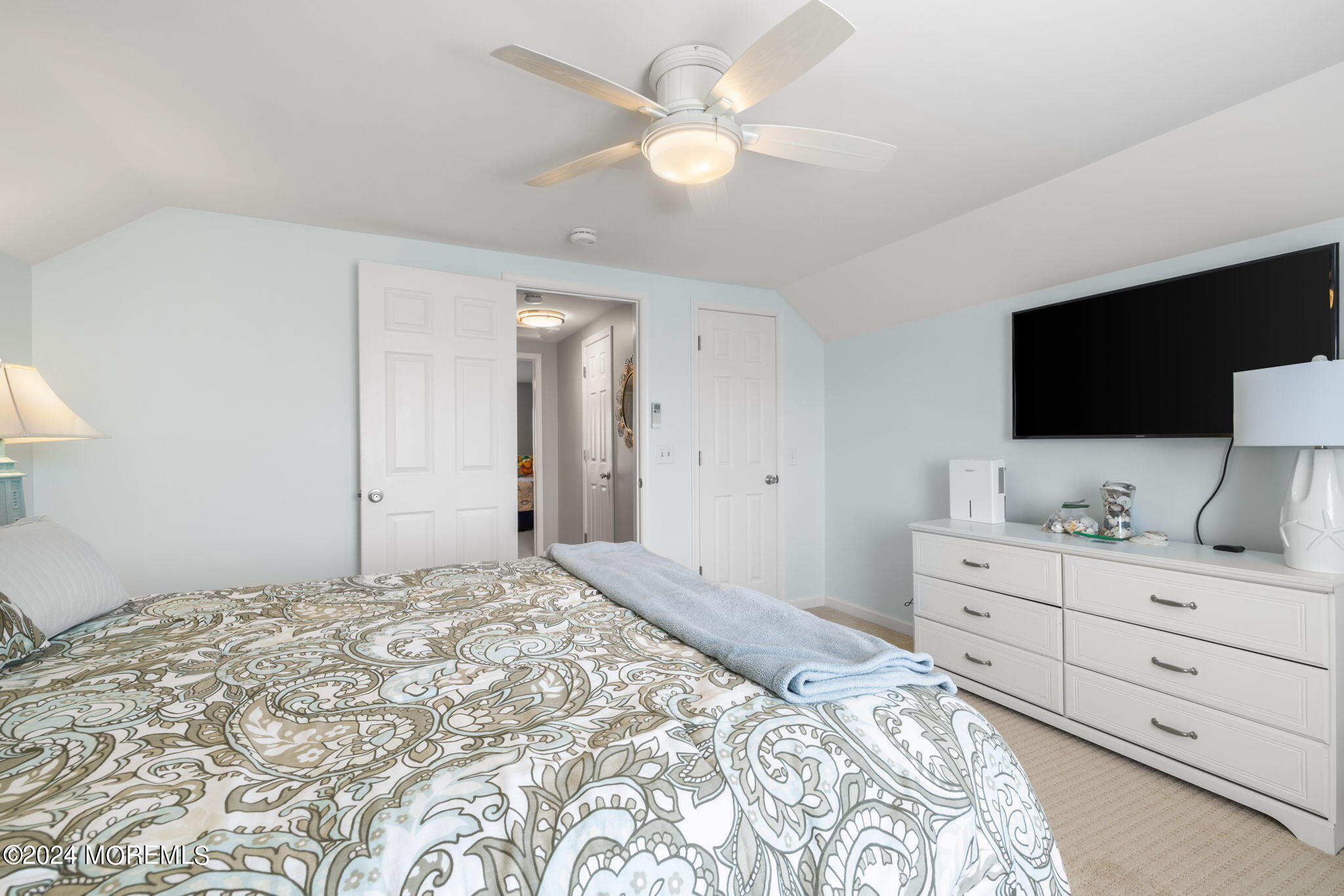 61 Rona Lane Beach Haven West, NJ 08050 - Photo 26 of 63 a bedroom with a large bed and a flat screen tv
