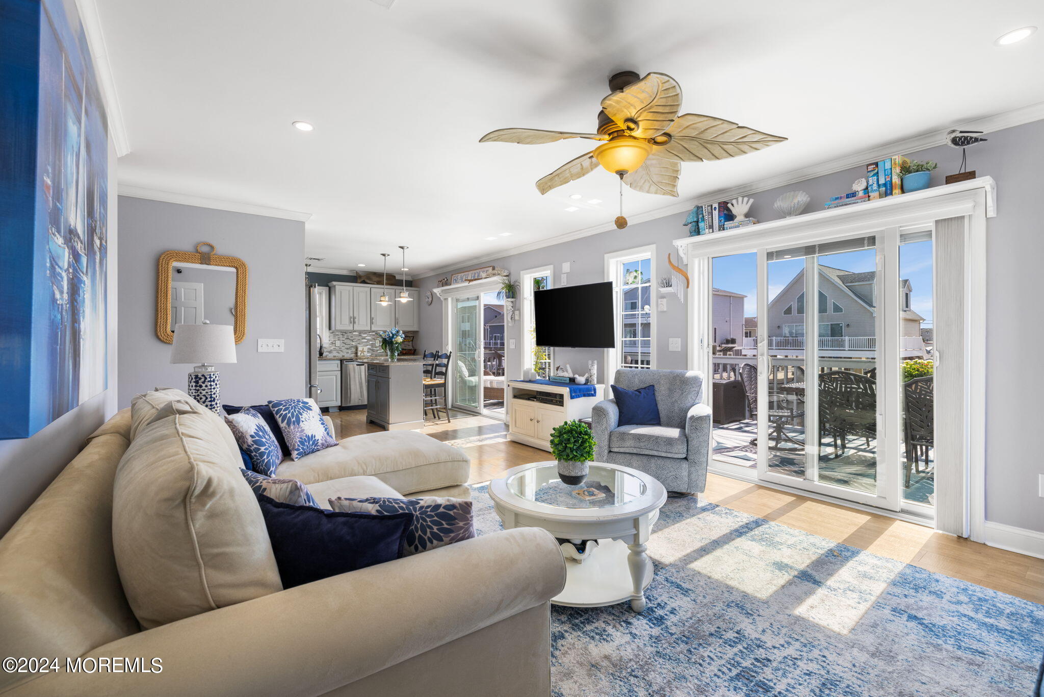 61 Rona Lane Beach Haven West, NJ 08050 - Photo 4 of 63 a living room with furniture a flat screen tv and a floor to ceiling window