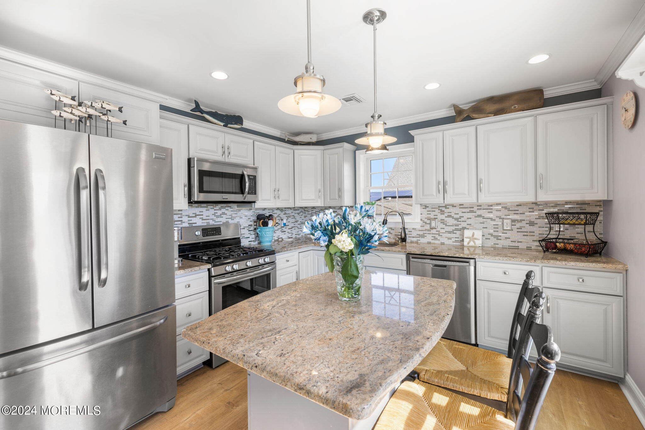 61 Rona Lane Beach Haven West, NJ 08050 - Photo 6 of 63 a kitchen with a refrigerator a stove a sink and white cabinets with wooden floor