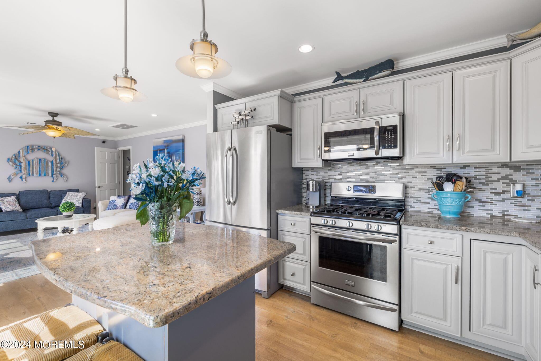 61 Rona Lane Beach Haven West, NJ 08050 - Photo 9 of 63 a kitchen with stainless steel appliances granite countertop a stove a refrigerator and a white cabinets