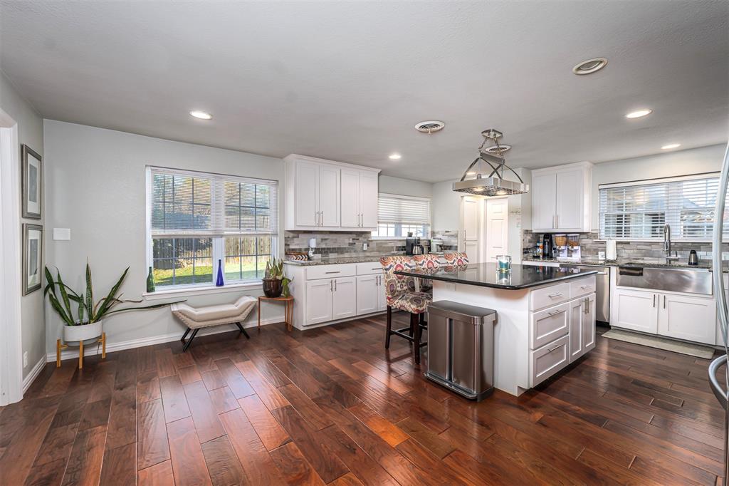 6512 Greenway Road Fort Worth, TX 76116 - Photo 13 of 38 Kitchen featuring a kitchen bar, white cabinets, dark wood finished floors, backsplash, and recessed lighting