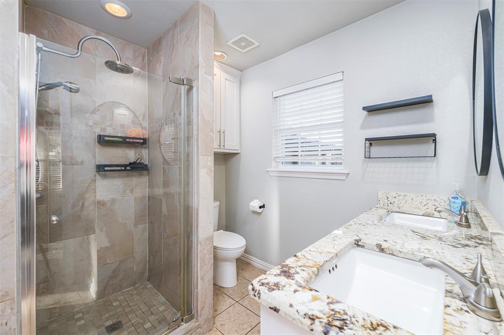 6512 Greenway Road Fort Worth, TX 76116 - Photo 15 of 38 Bathroom with double vanity, a stall shower, light tile patterned flooring, and recessed lighting