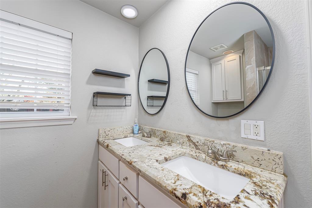 6512 Greenway Road Fort Worth, TX 76116 - Photo 16 of 38 Full bathroom with a textured wall and double vanity