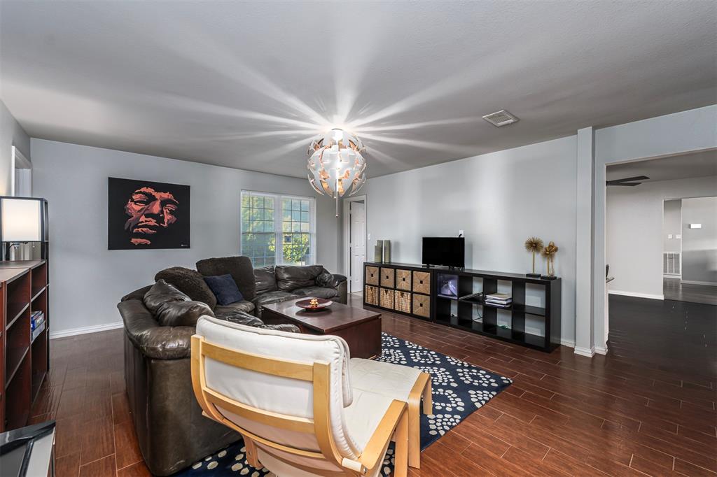 6512 Greenway Road Fort Worth, TX 76116 - Photo 20 of 38 Living room with wood tiled floors and a chandelier