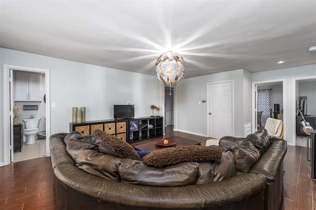 6512 Greenway Road Fort Worth, TX 76116 - Photo 27 of 38 Living area featuring wood finish floors and a chandelier