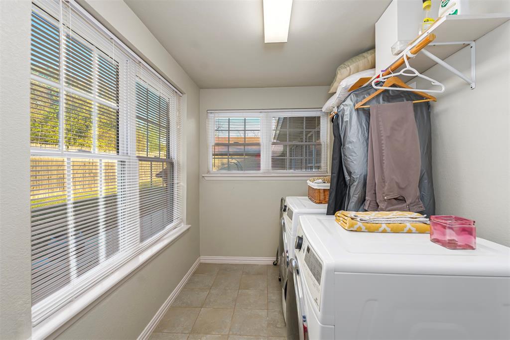 6512 Greenway Road Fort Worth, TX 76116 - Photo 28 of 38 Laundry room featuring washer and clothes dryer and light tile patterned floors