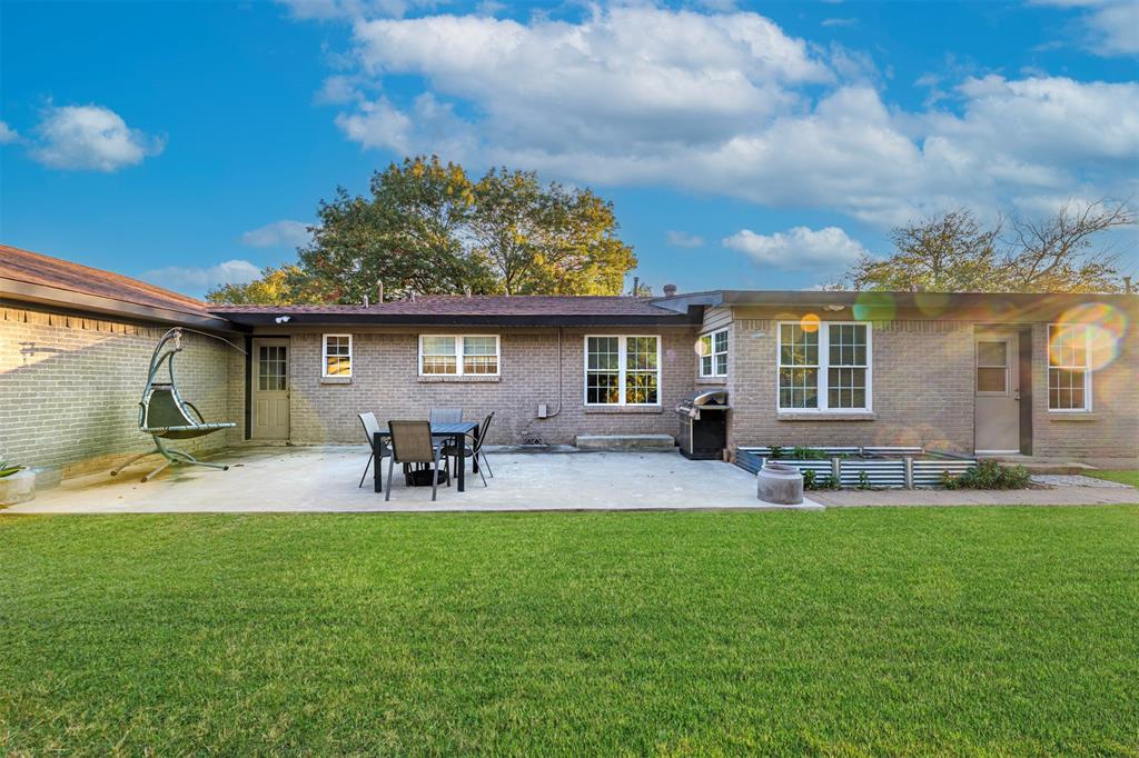 6512 Greenway Road Fort Worth, TX 76116 - Photo 31 of 38 Rear view of house with a patio area, brick siding, and a lawn