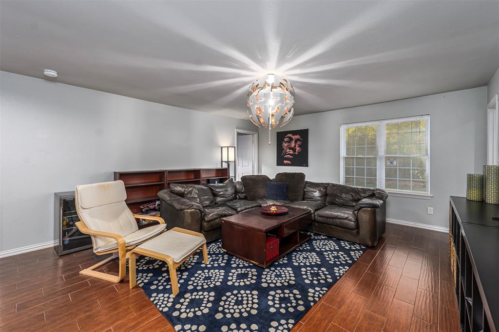 6512 Greenway Road Fort Worth, TX 76116 - Photo 8 of 38 Living area featuring wood finish floors and a chandelier