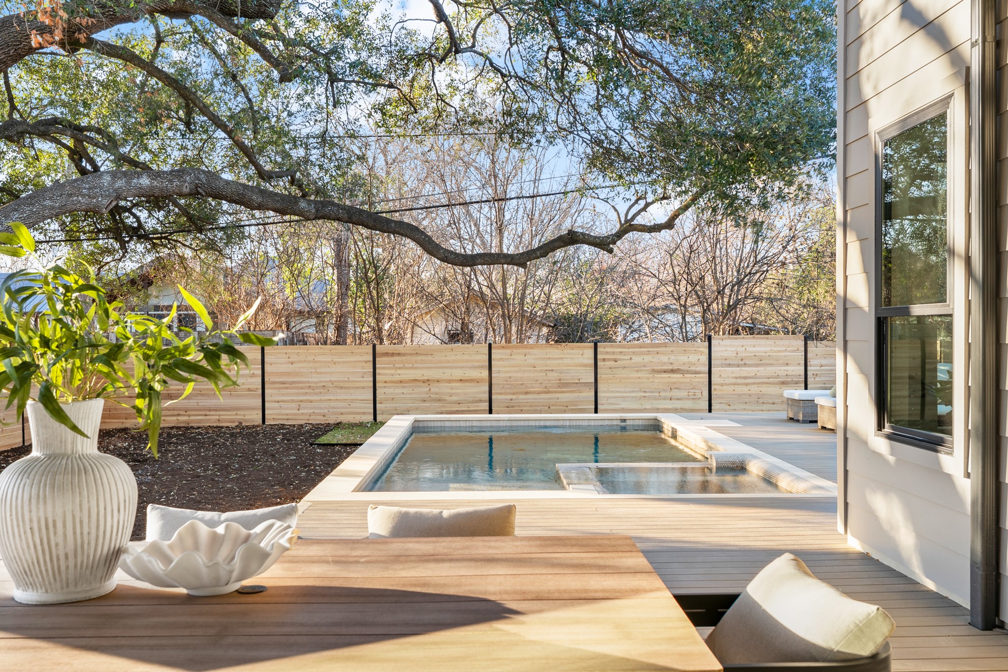 7706 Rutgers Avenue Austin, TX 78757 - Photo 10 of 35 Wooden deck with a fenced backyard and a jacuzzi