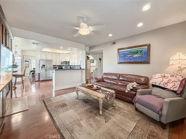 a living room with furniture and kitchen view