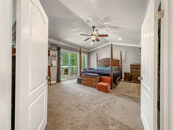 a spacious bedroom with a large bed closet and flat screen tv