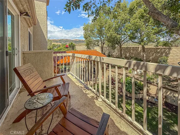a bedroom with a bed and a flat tv screen on the dresser