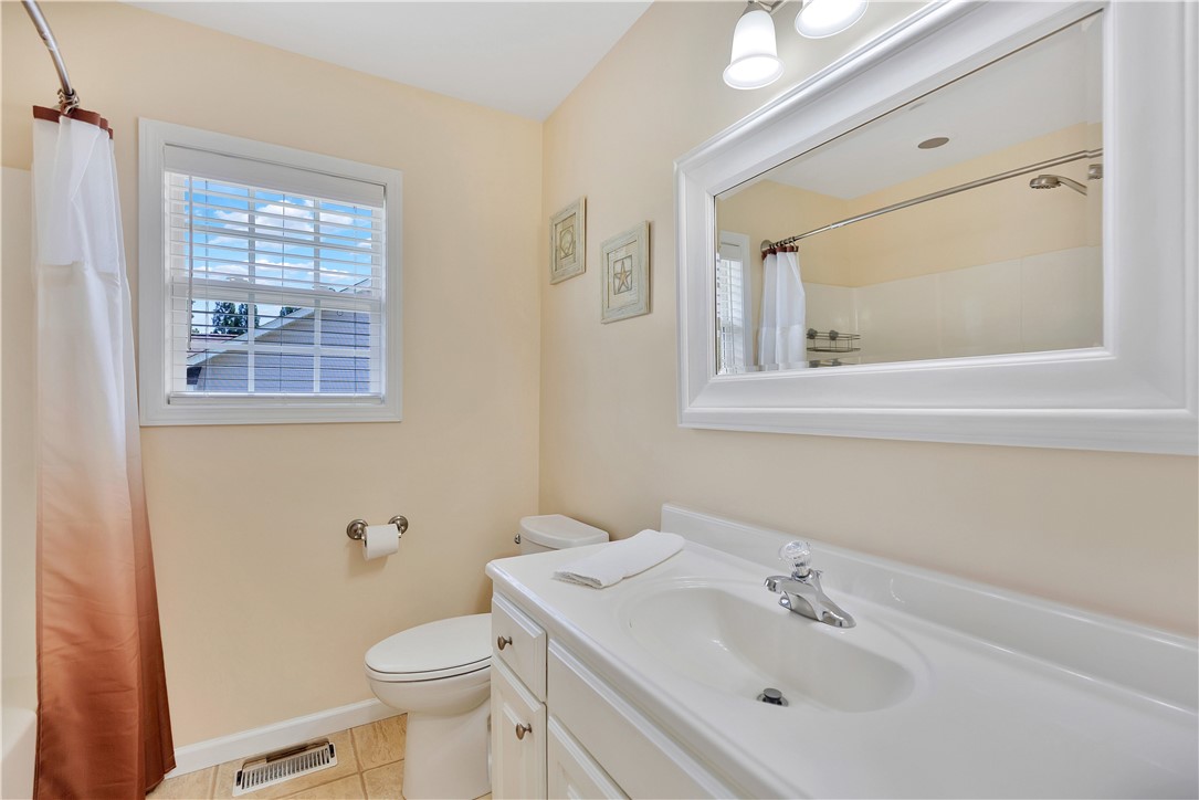 131 Morgan Road West Union, SC 29696 - Photo 17 of 39 A well-lit bathroom featuring a large framed mirror above a pristine vanity.