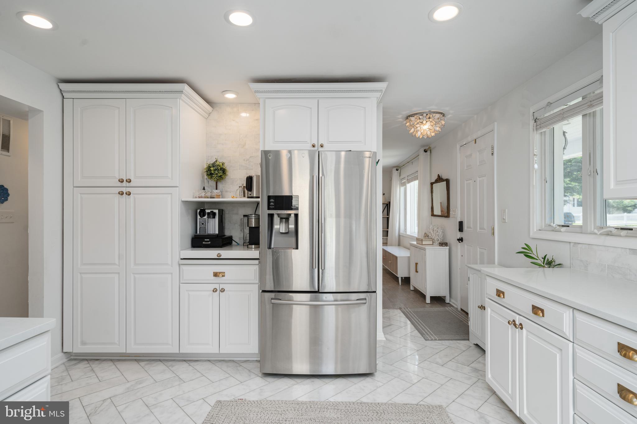 6401 Winnepeg Road Bethesda, MD 20817 - Photo 14 of 41 a kitchen with stainless steel appliances a refrigerator sink and cabinets