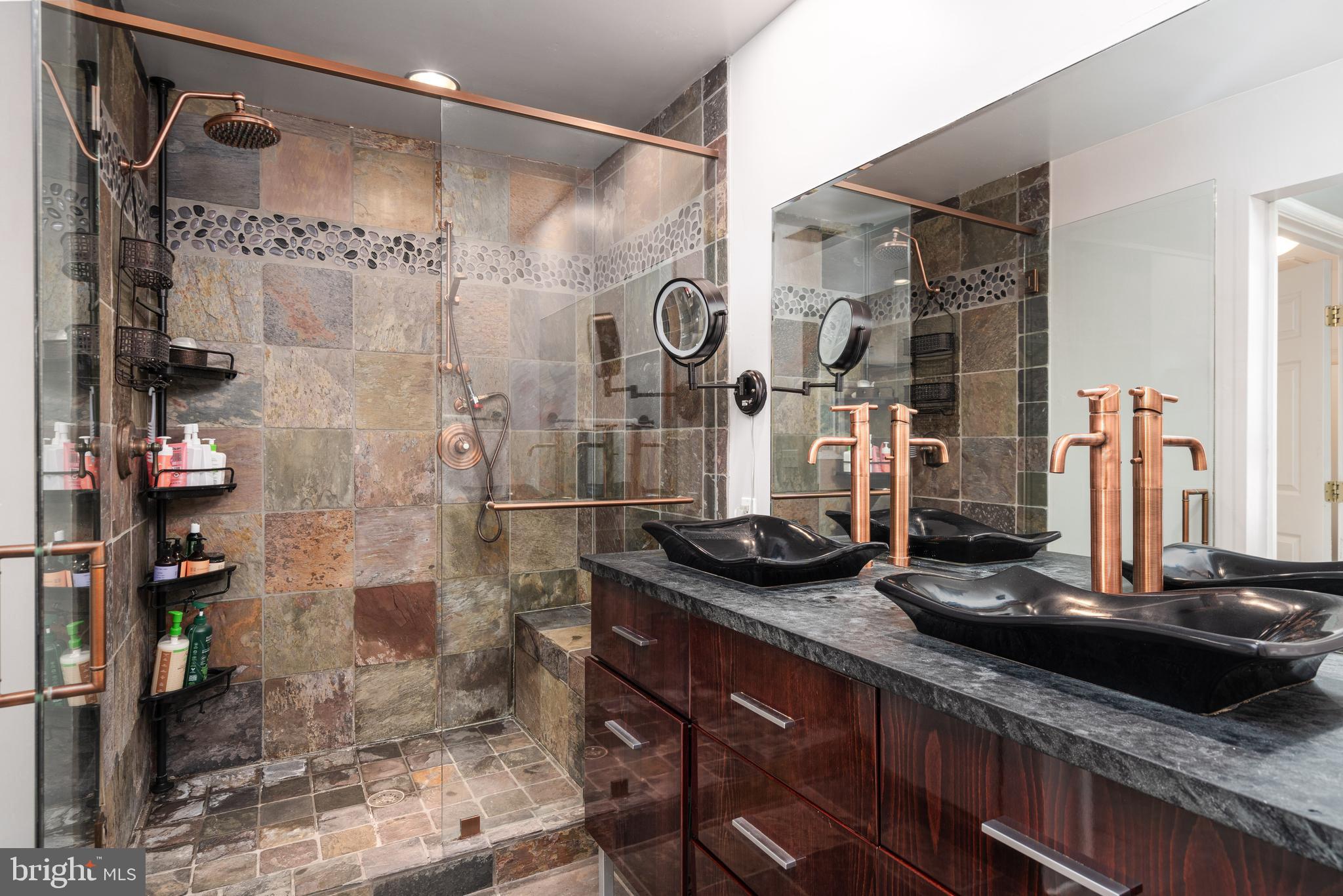 6401 Winnepeg Road Bethesda, MD 20817 - Photo 28 of 41 a bathroom with a granite countertop shower a sink and a mirror