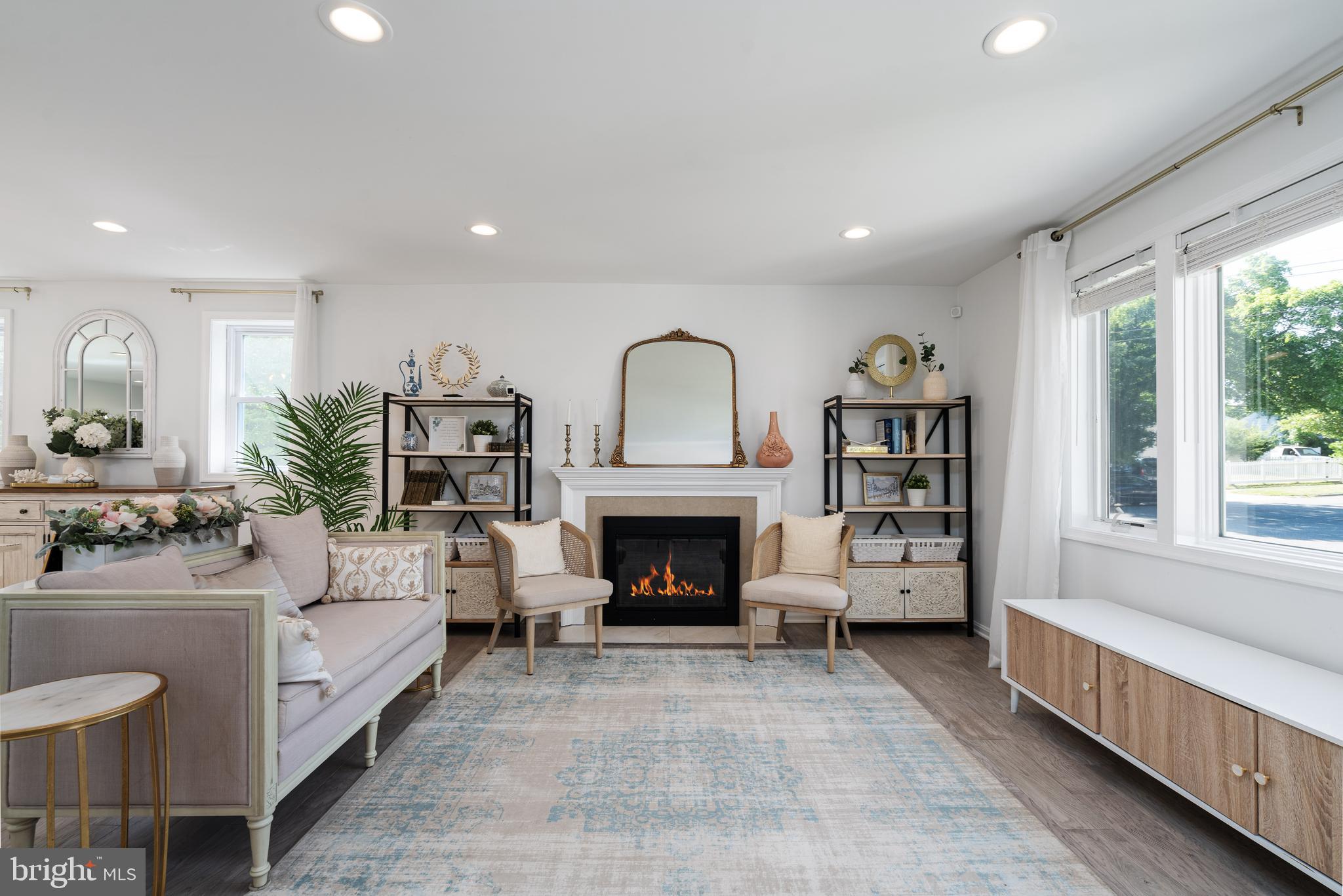 6401 Winnepeg Road Bethesda, MD 20817 - Photo 4 of 41 a living room with furniture a fireplace and a large window