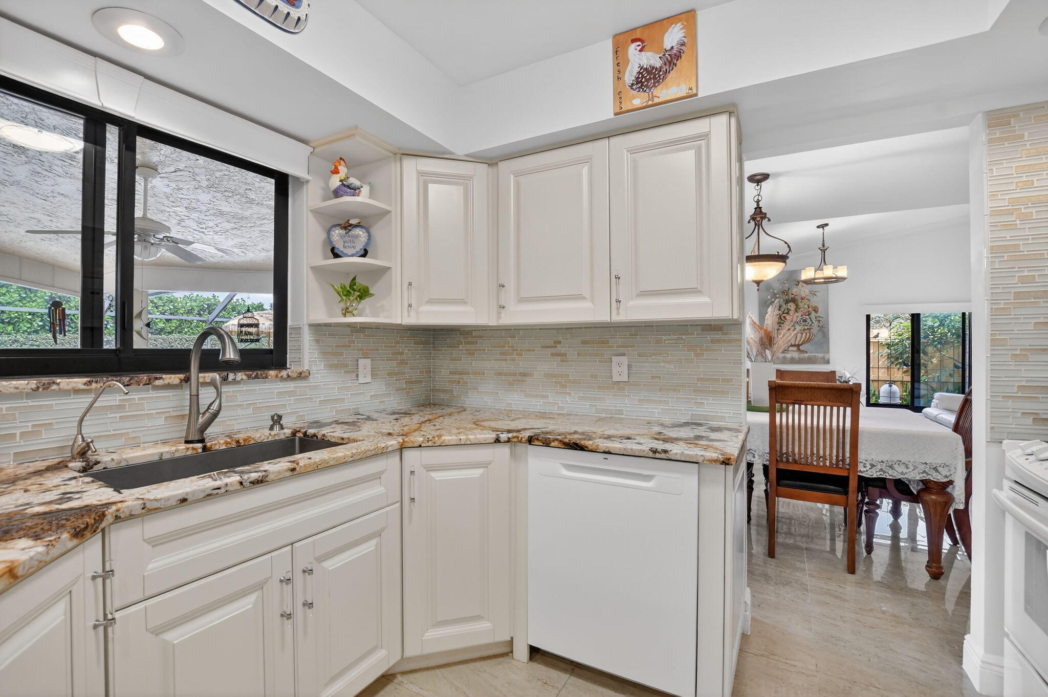 4205 Birchwood Drive Boca Raton, FL 33487 - Photo 22 of 75 a kitchen with a sink cabinets and window