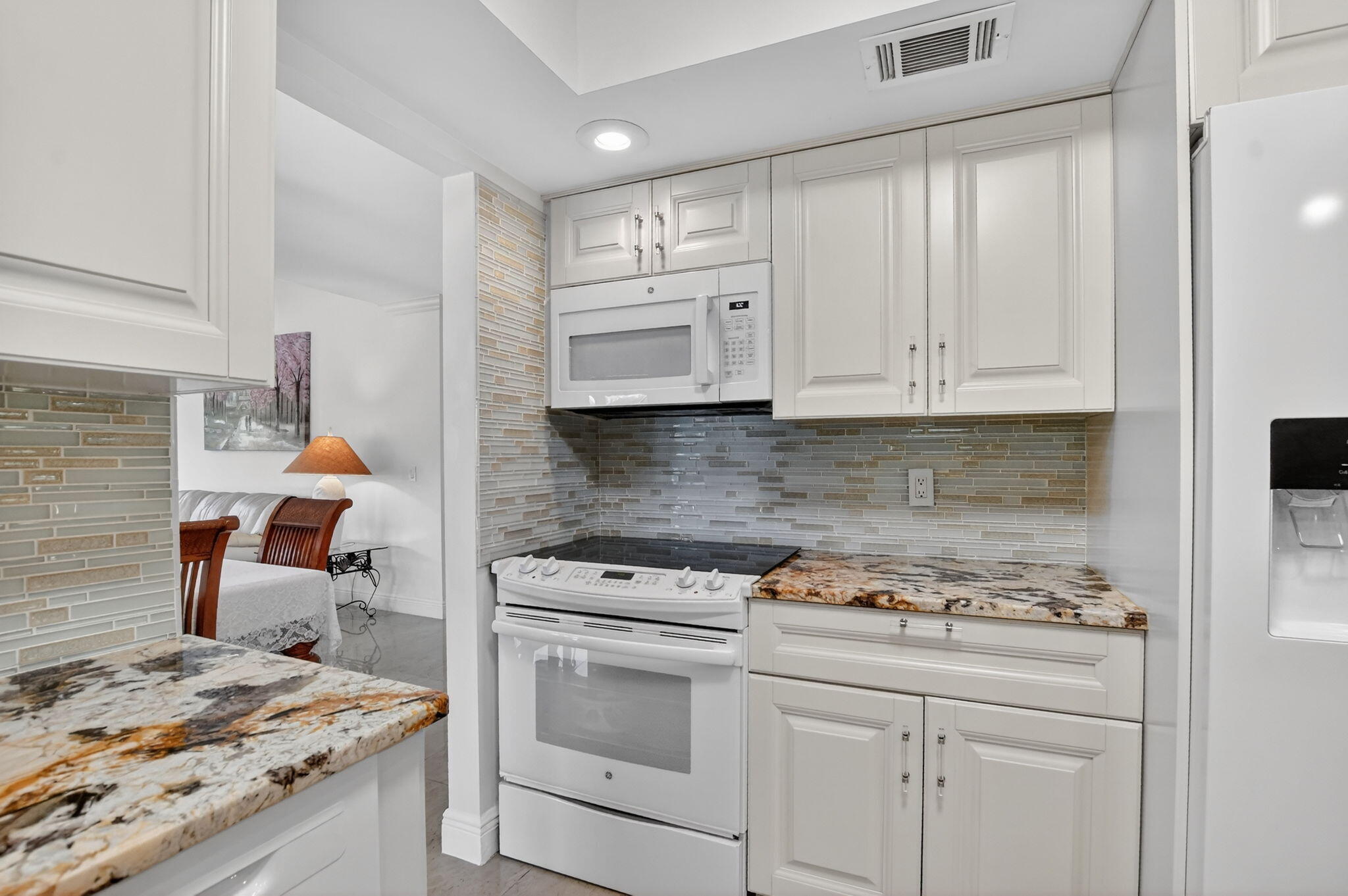 4205 Birchwood Drive Boca Raton, FL 33487 - Photo 24 of 75 a kitchen with stainless steel appliances granite countertop a stove a sink and a microwave
