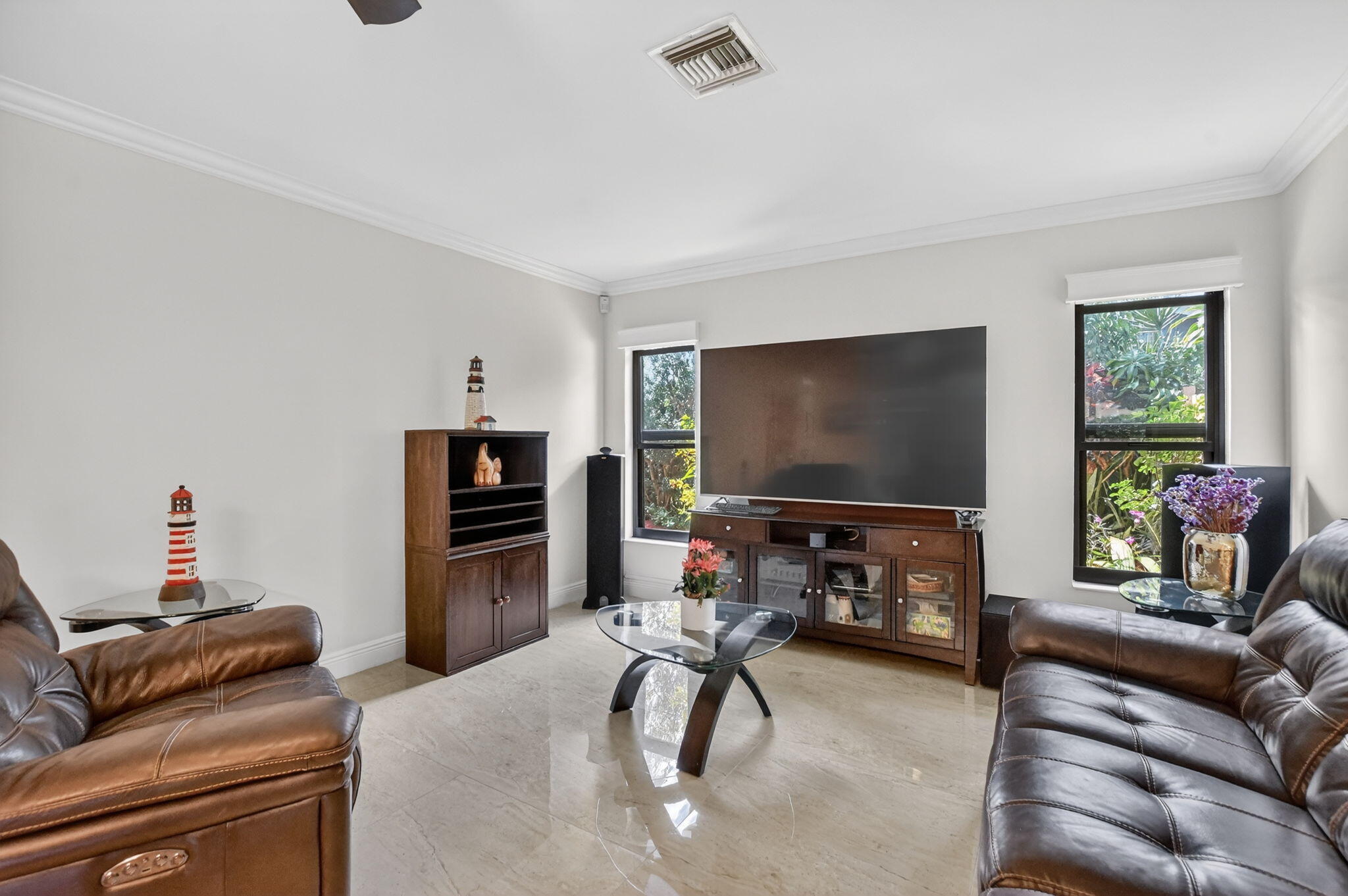 4205 Birchwood Drive Boca Raton, FL 33487 - Photo 29 of 75 a living room with furniture and a flat screen tv
