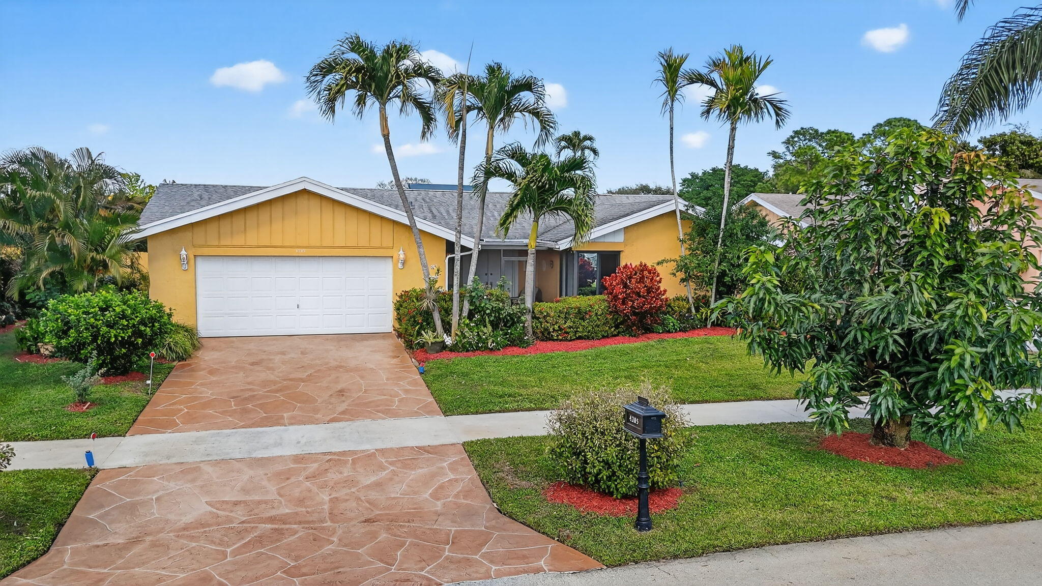 4205 Birchwood Drive Boca Raton, FL 33487 - Photo 3 of 75 a front view of house with yard and green space