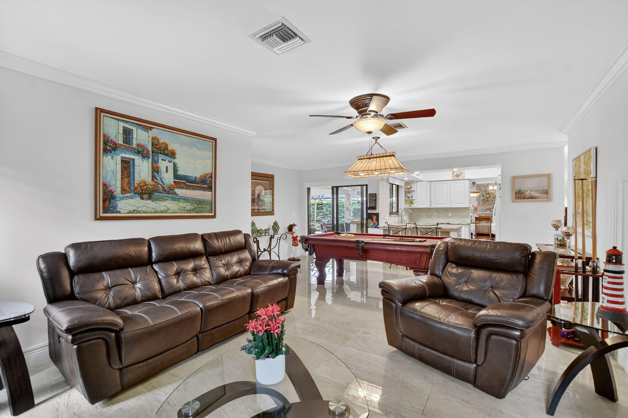 4205 Birchwood Drive Boca Raton, FL 33487 - Photo 31 of 75 a living room with furniture a chandelier and a ceiling fan