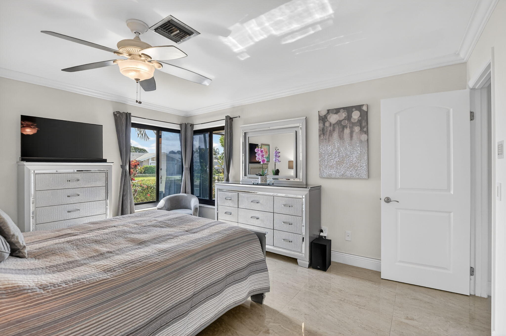 4205 Birchwood Drive Boca Raton, FL 33487 - Photo 34 of 75 a bedroom with a large bed and a flat tv screen on dresser