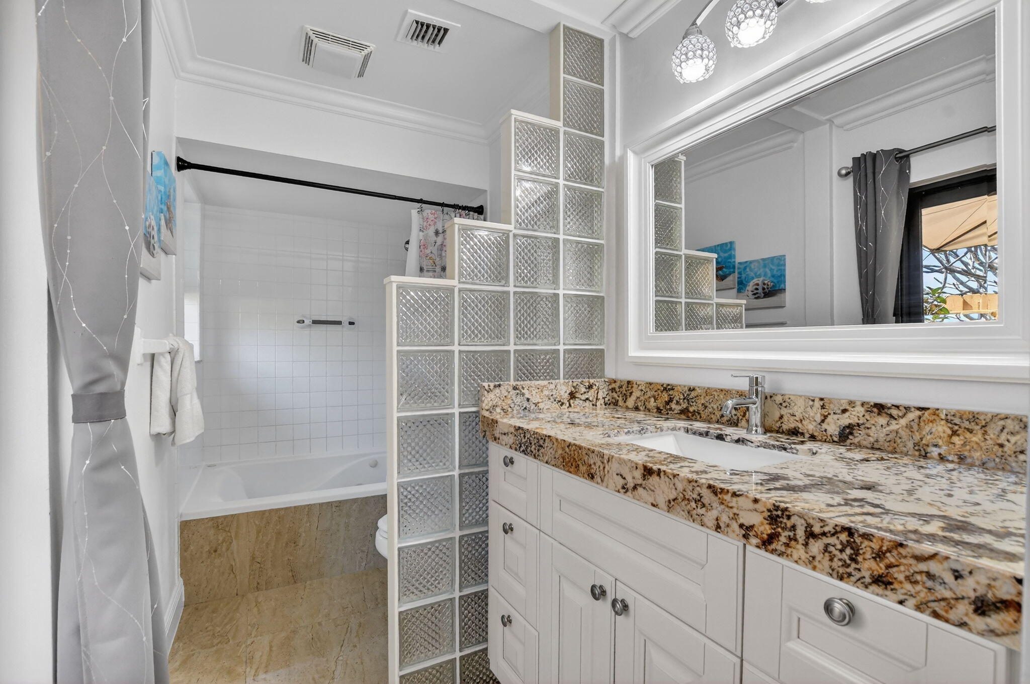 4205 Birchwood Drive Boca Raton, FL 33487 - Photo 38 of 75 a bathroom with a granite countertop sink a mirror and shower