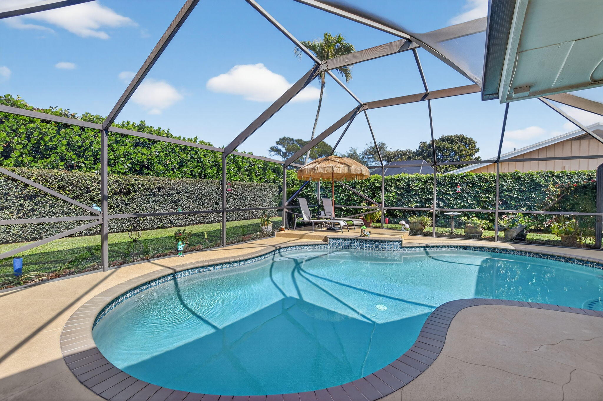 4205 Birchwood Drive Boca Raton, FL 33487 - Photo 56 of 75 a view of a swimming pool with a porch