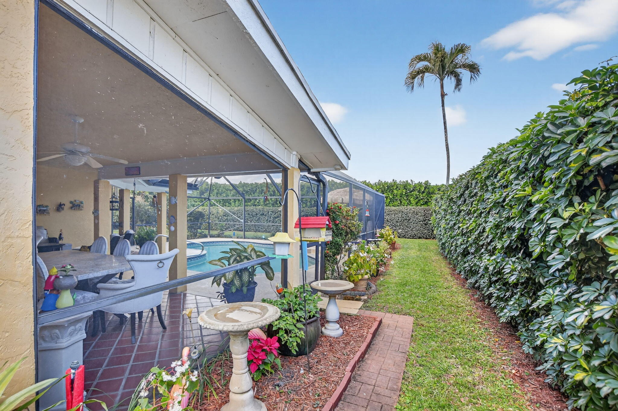 4205 Birchwood Drive Boca Raton, FL 33487 - Photo 64 of 75 a view of a patio with table and chairs potted plants