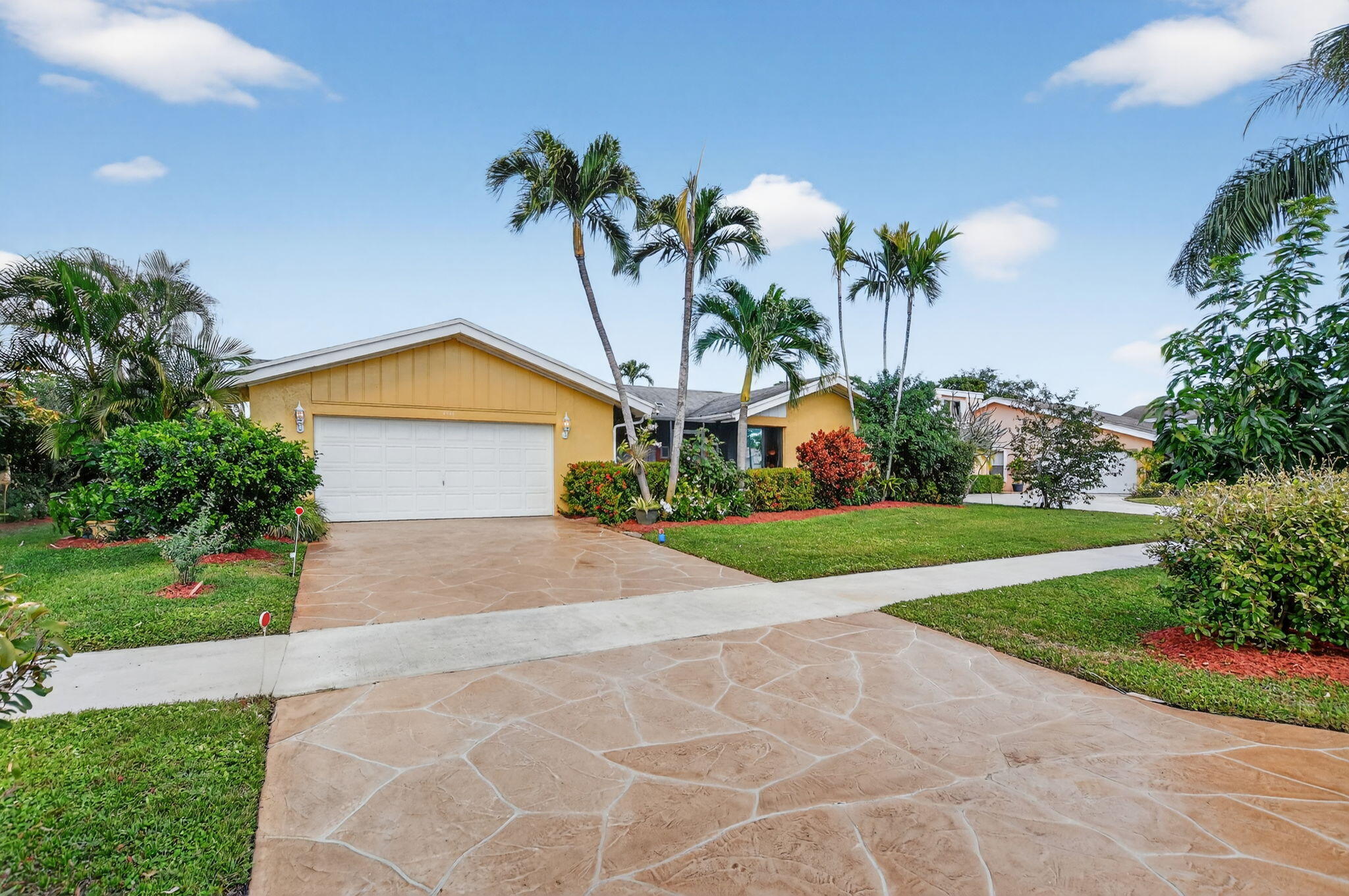 4205 Birchwood Drive Boca Raton, FL 33487 - Photo 8 of 75 a front view of house with yard and green space