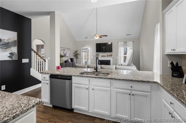 a kitchen with granite countertop a sink and cabinets