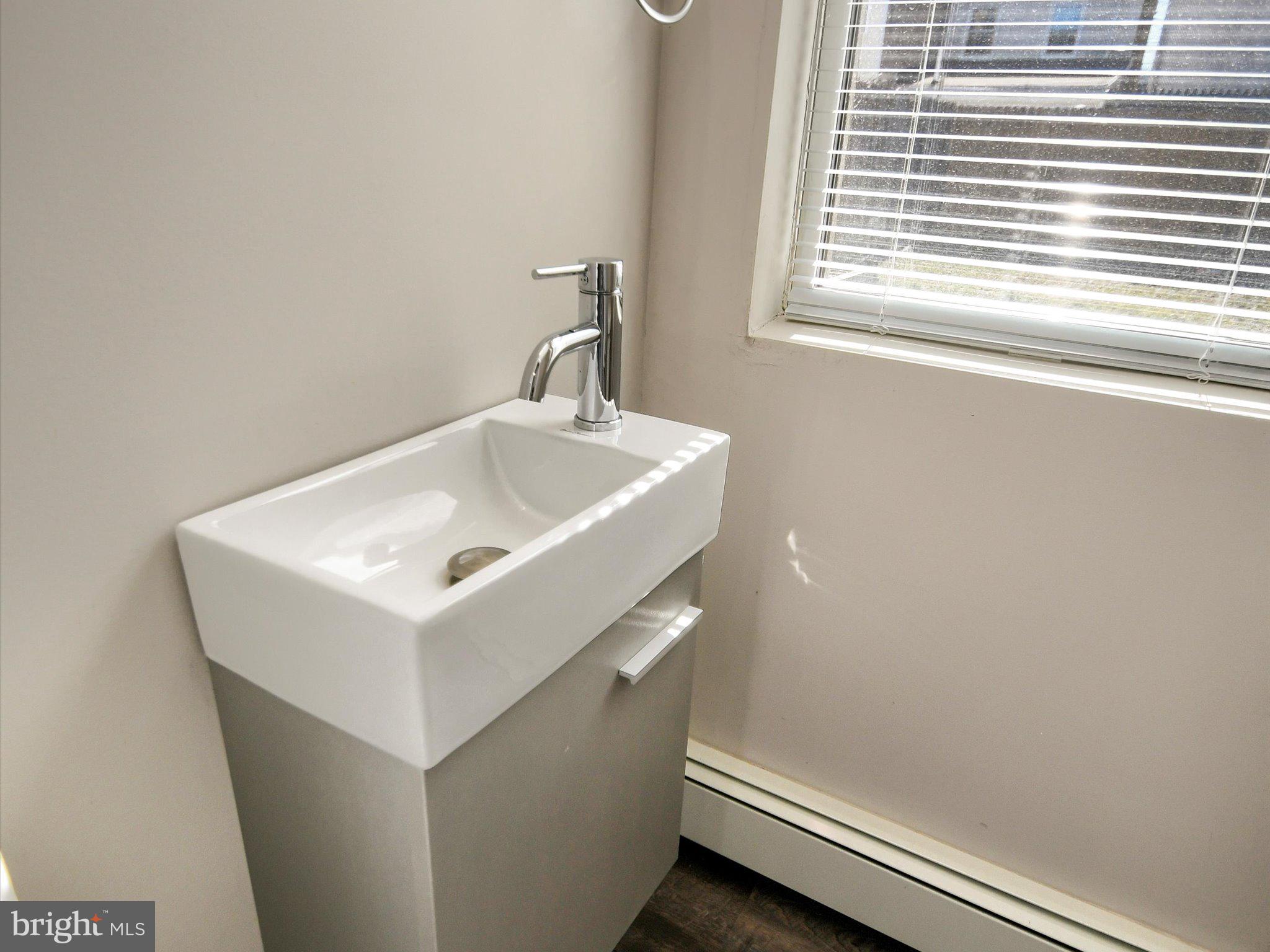 24 West Front Street Bridgeport, PA 19405 - Photo 11 of 32 a white sink sitting under a window