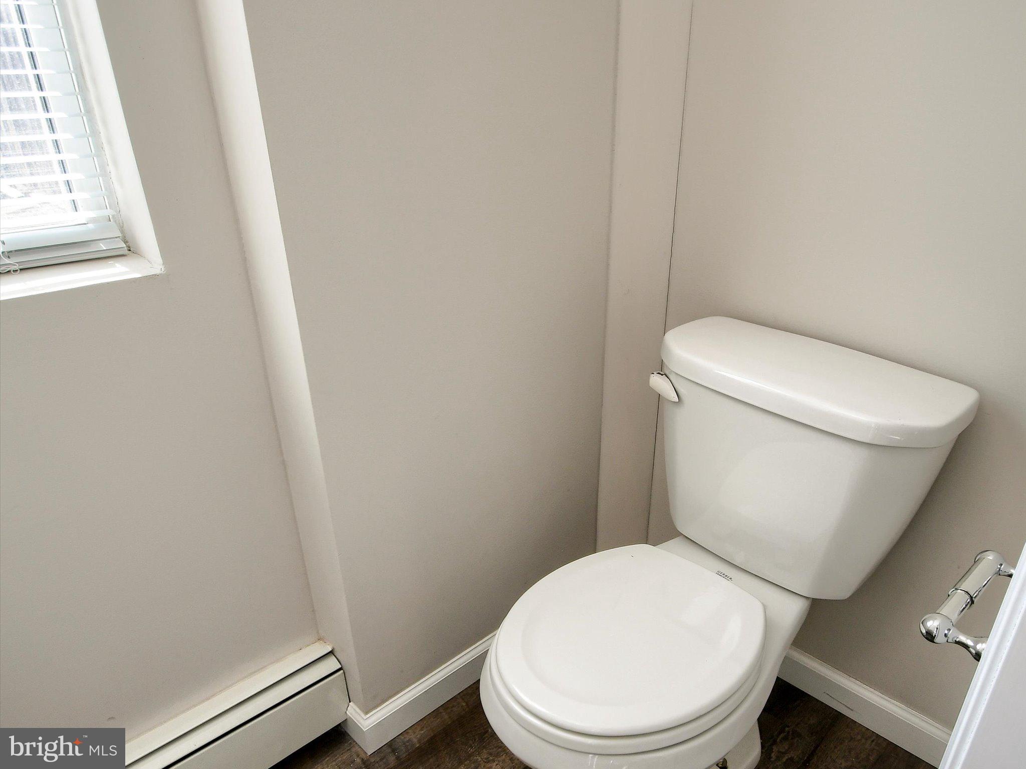 24 West Front Street Bridgeport, PA 19405 - Photo 12 of 32 a white toilet sitting next to a small window