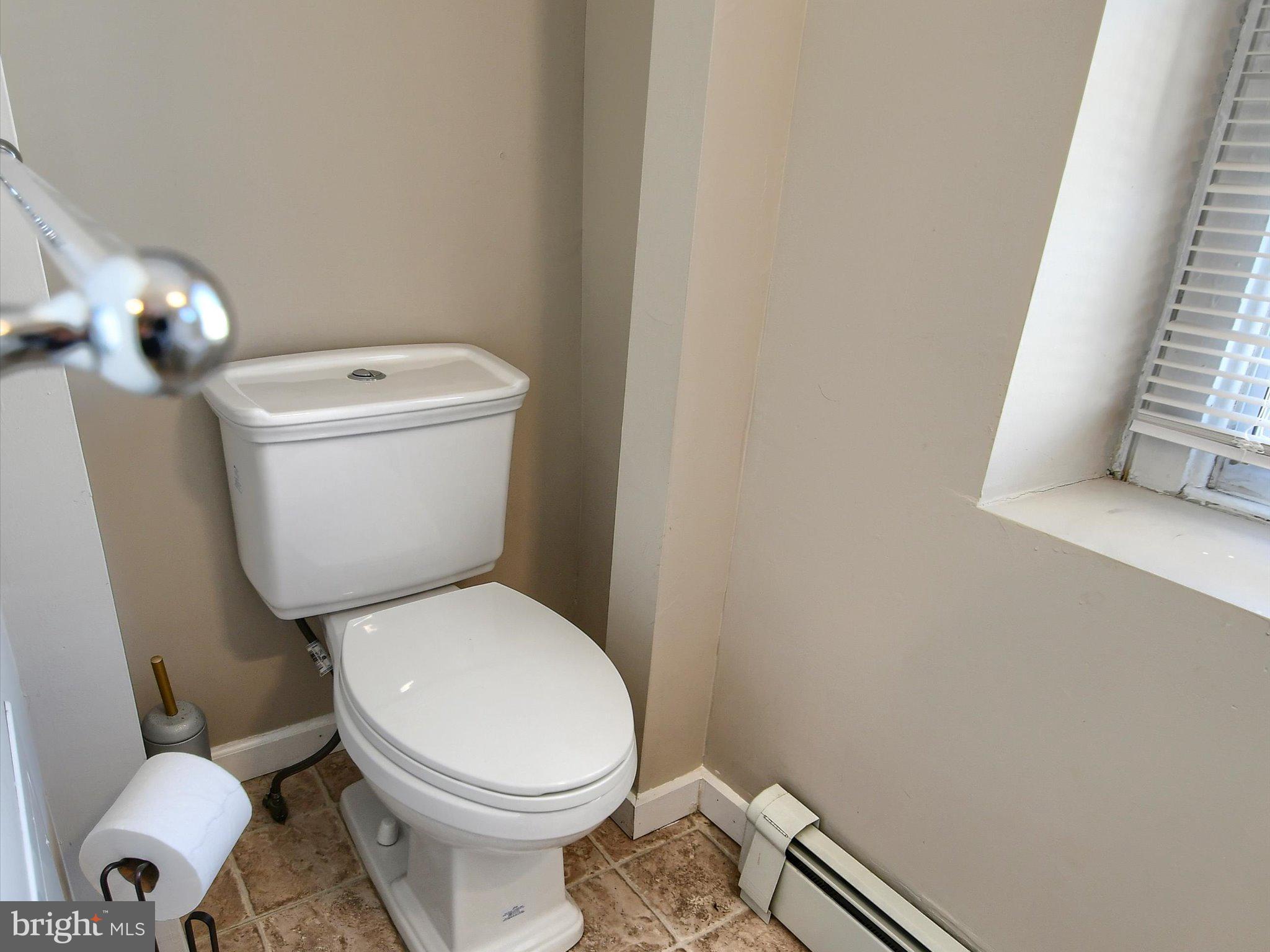 24 West Front Street Bridgeport, PA 19405 - Photo 19 of 32 a white toilet sitting next to a bathroom sink