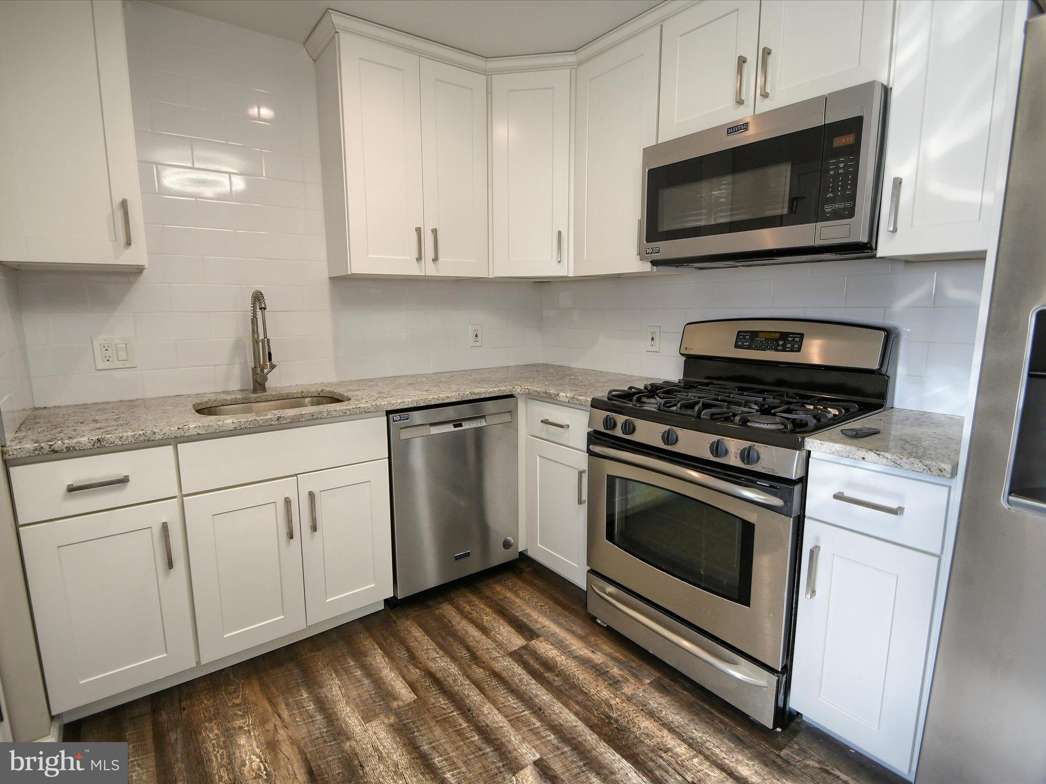 24 West Front Street Bridgeport, PA 19405 - Photo 9 of 32 a kitchen with granite countertop a sink cabinets and stainless steel appliances