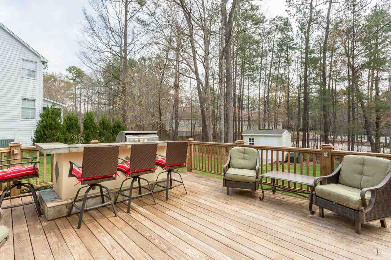 5600 Crossfield Drive Raleigh, NC 27613 - Photo 20 of 25 The custom-built deck and outdoor kitchen is a grill-master's delight! The deck has so many custom details with attention to craftsmanship. Large Deck with Outdoor Kitchen