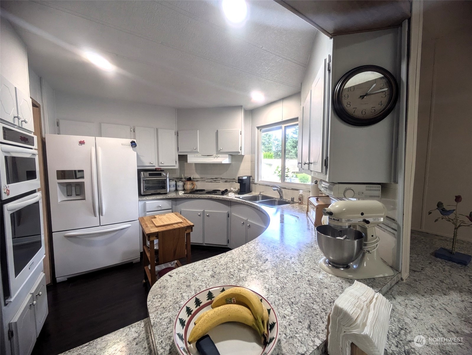 201 Union Avenue Southeast, Unit 104 Renton, WA 98059 - Photo 12 of 36 a living room with stainless steel appliances furniture a rug and a window
