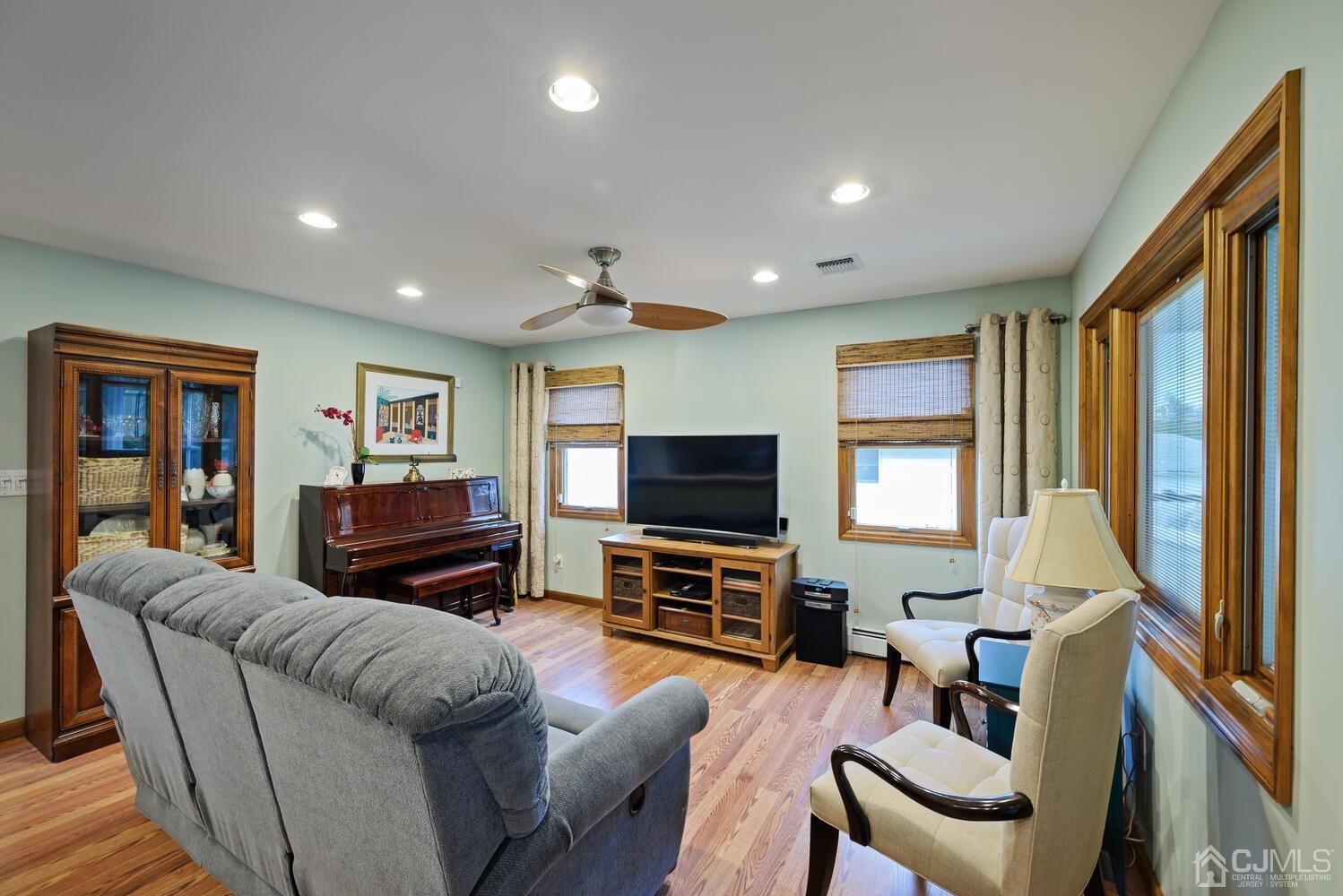 28 Rector Avenue Woodbridge, NJ 07095 - Photo 15 of 32 a living room with furniture a flat screen tv and a large window