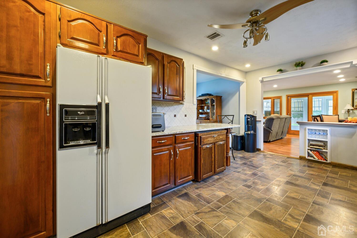 28 Rector Avenue Woodbridge, NJ 07095 - Photo 18 of 32 a large kitchen with stainless steel appliances granite countertop a refrigerator a stove and a sink with cabinets