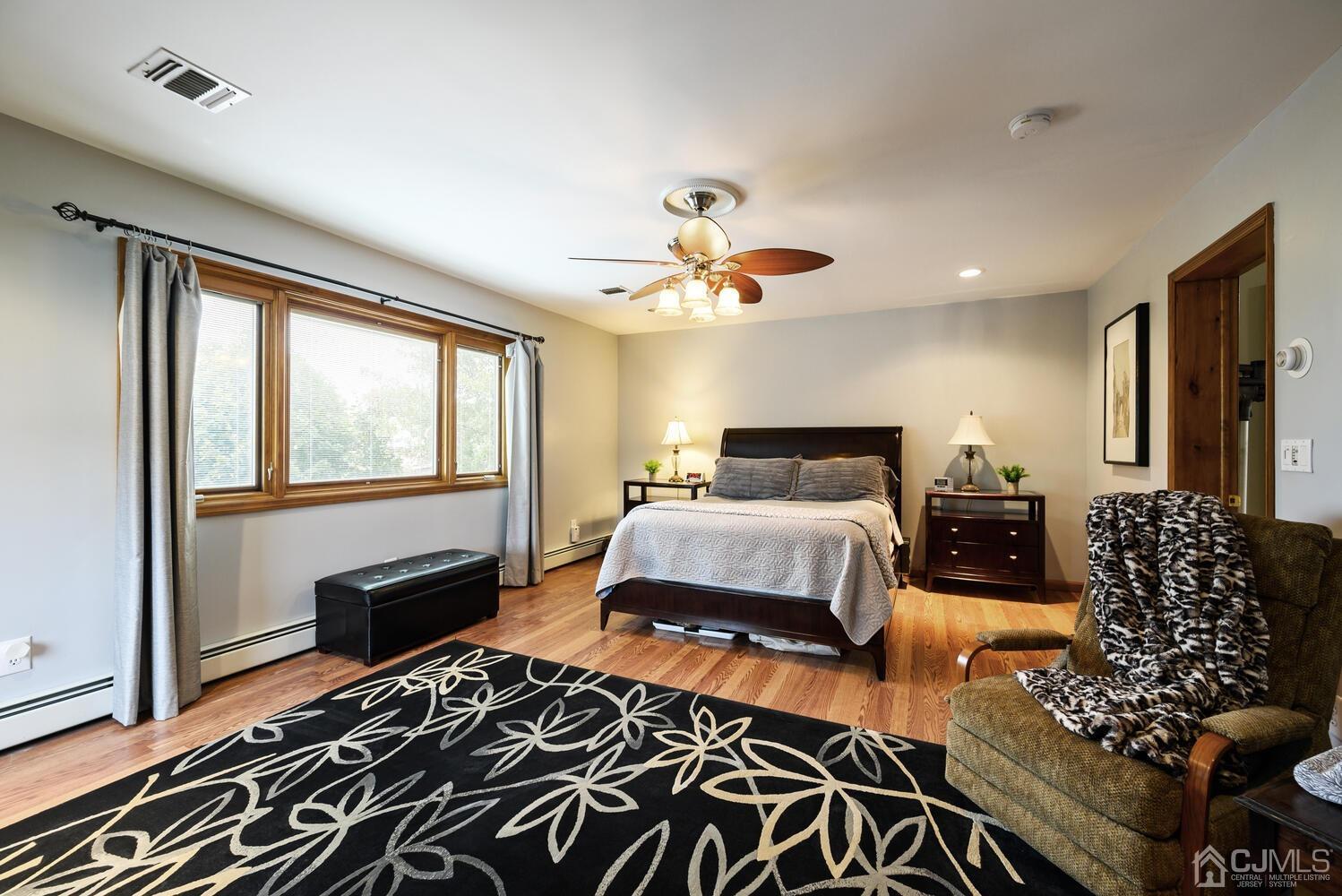 28 Rector Avenue Woodbridge, NJ 07095 - Photo 20 of 32 a bedroom with a bed and a chandelier