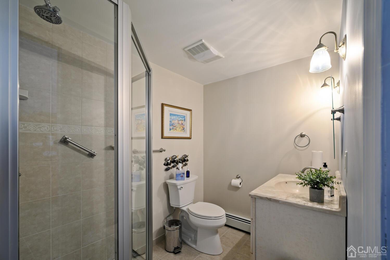 28 Rector Avenue Woodbridge, NJ 07095 - Photo 25 of 32 a bathroom with a toilet and a shower